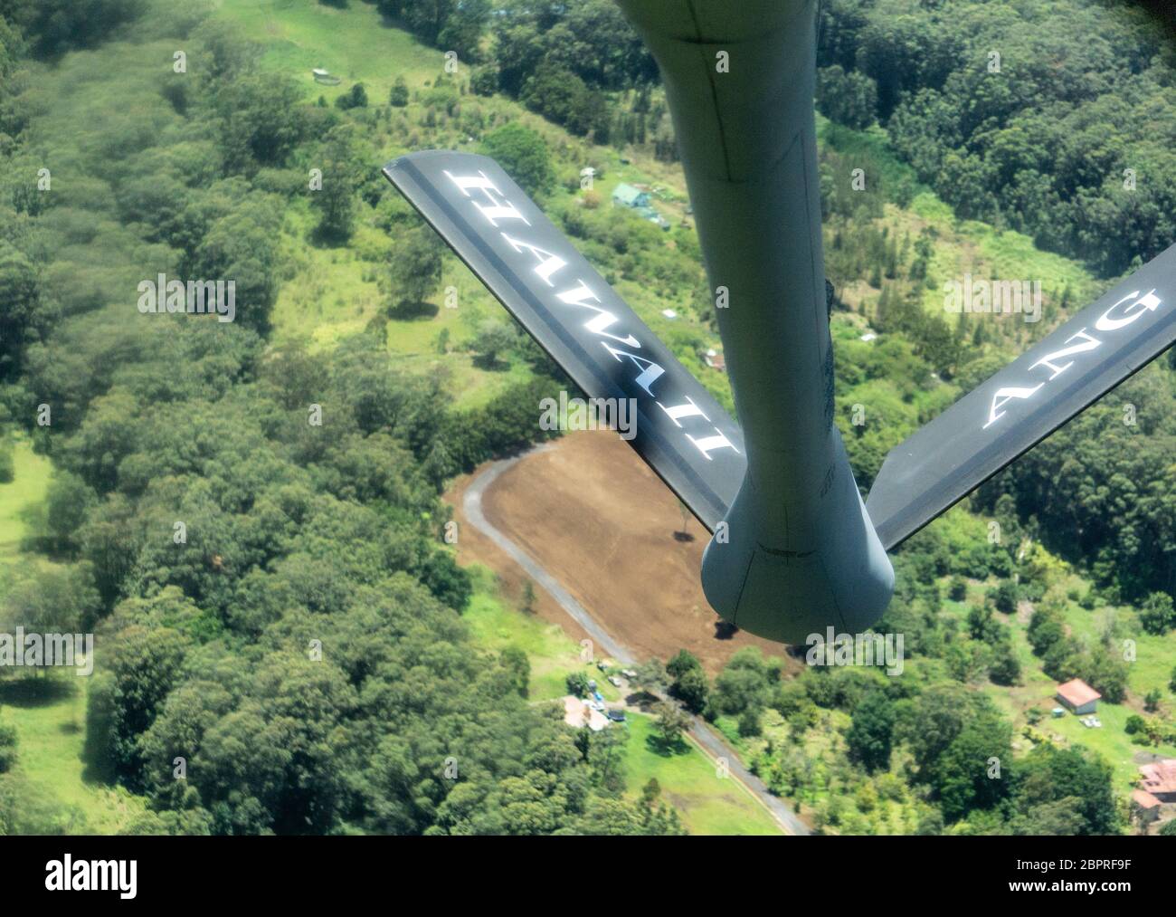 A KC-135 Stratotanker operated by Team Hickam passes over the Hawaiian Islands, May 14, 2020. Aircrews from the Hawaii Air National Guard and 15th Wing conducted a flyover as part of Operation American Resolve throughout the Hawaiian Islands as a salute to all frontline workers battling COVID-19, as well as those staying home to 'flatten the curve of transmission' of the virus. (U.S. Air National Guard photo by Tech. Sgt. Alison Bruce-Maldonado) Stock Photo