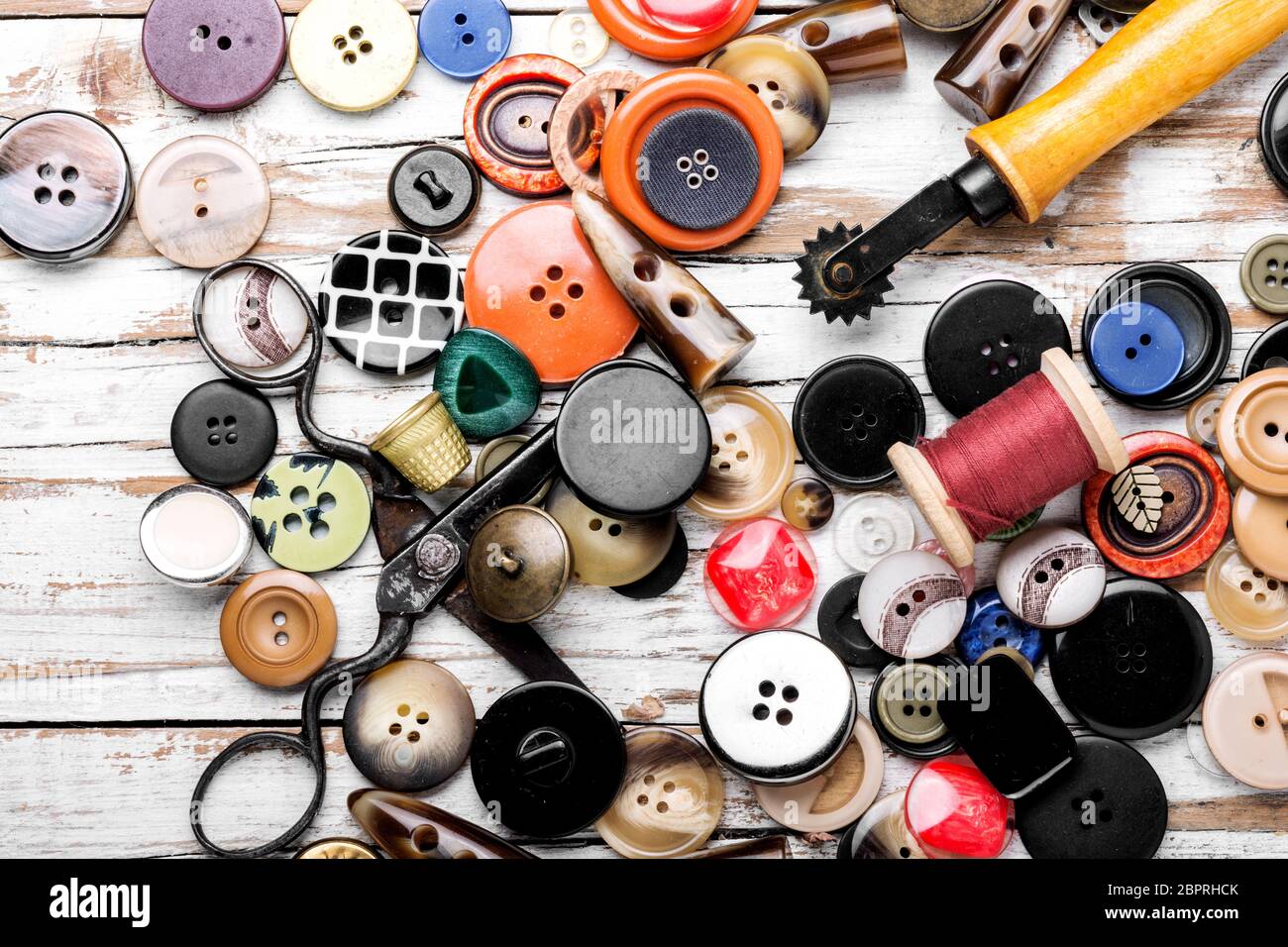 Spools of threads and buttons on wooden table. Sewing tool Stock Photo ...