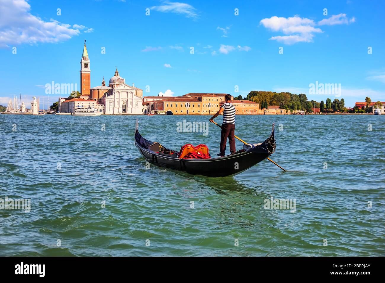 A gondolier in Venice going to San Giorgio Maggiore island, Italy. Stock Photo
