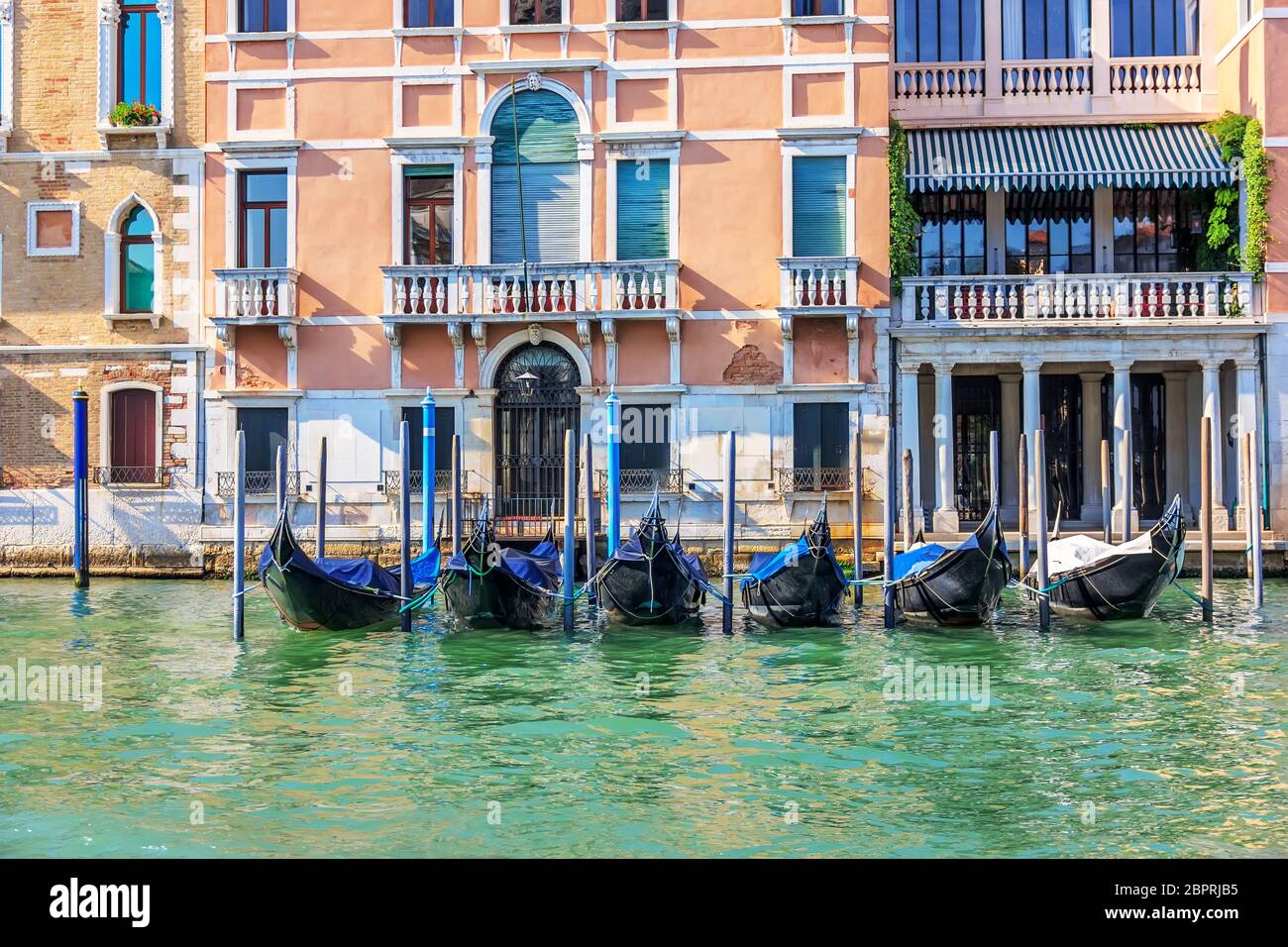 Gondolas moored on the Grand Canal of Venice, summer view. Stock Photo