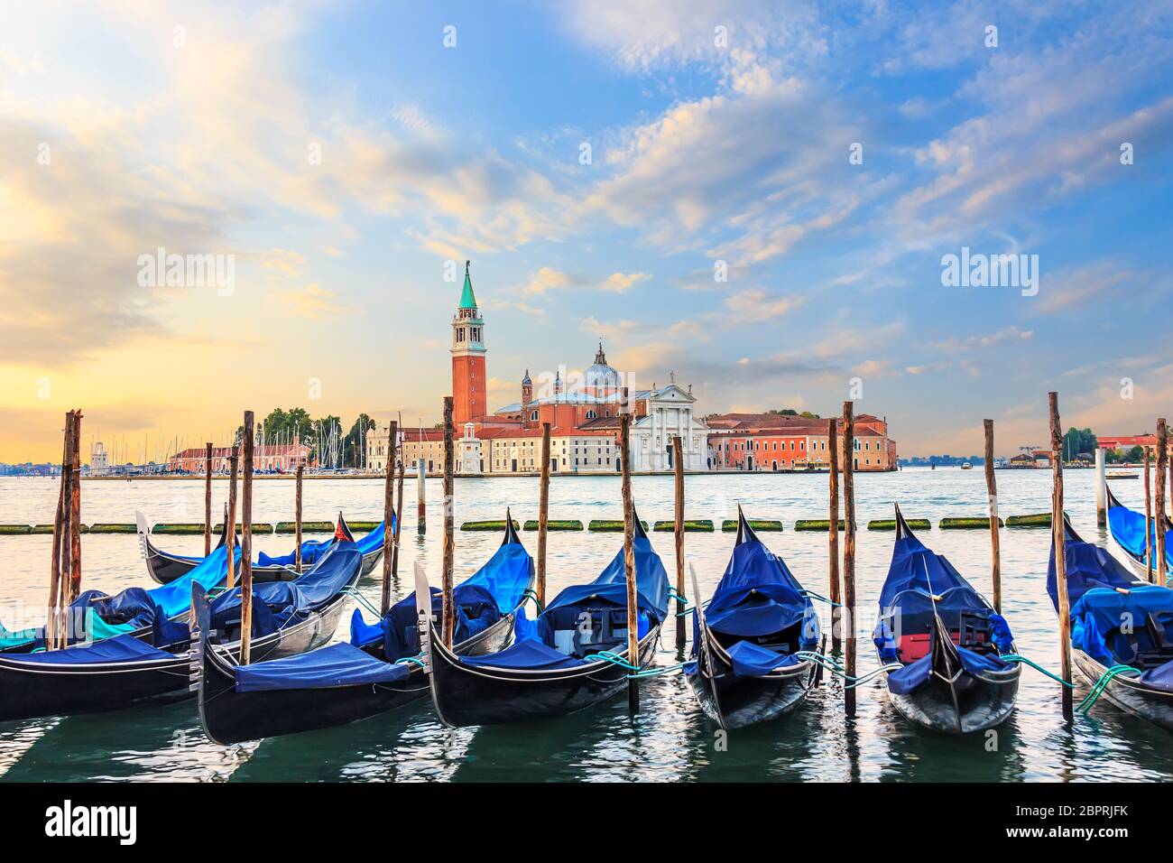 Gondolas moored at the pier in Grand Canal with San Giorgio Maggiore in the background, Venice, Italy. Stock Photo