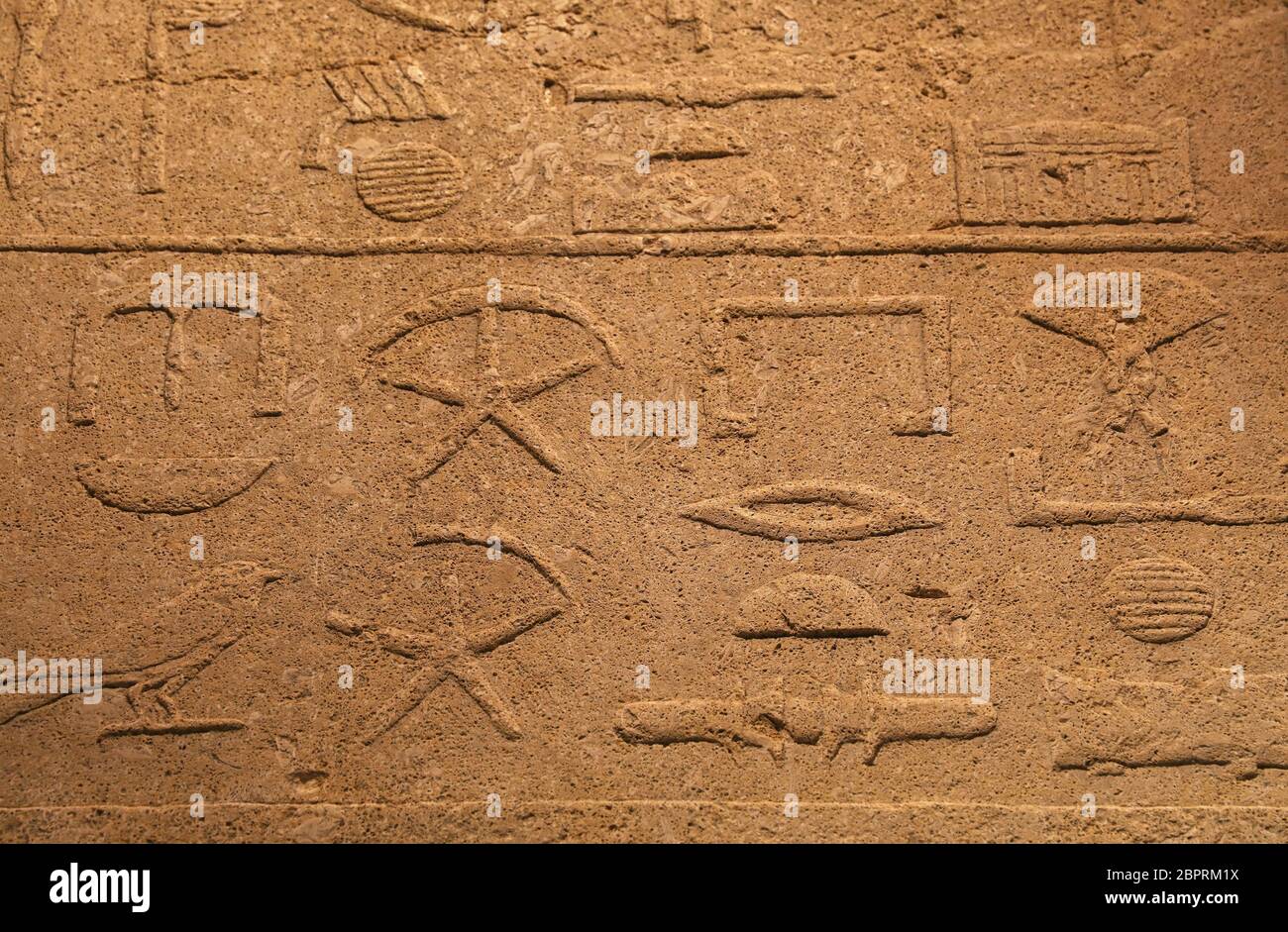 Close up background of antique stone wall with carved ancient Egyptian ...