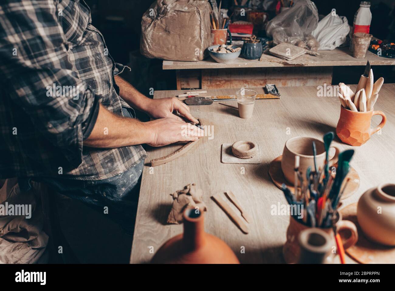 Process of creating a clay cup in pottery workshop Stock Photo
