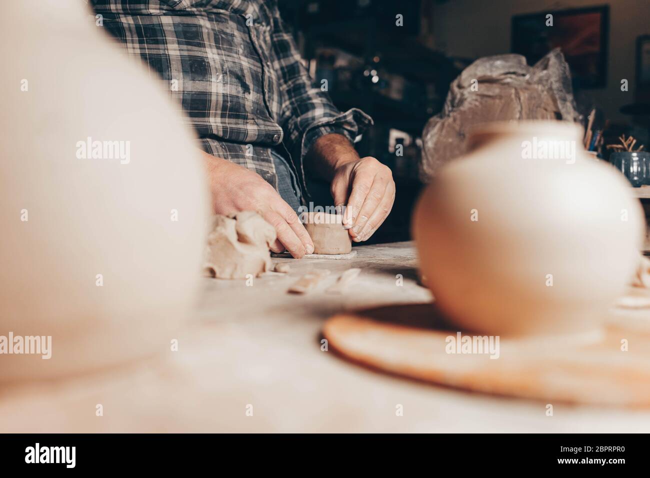 Process of creating a clay cup in pottery workshop Stock Photo
