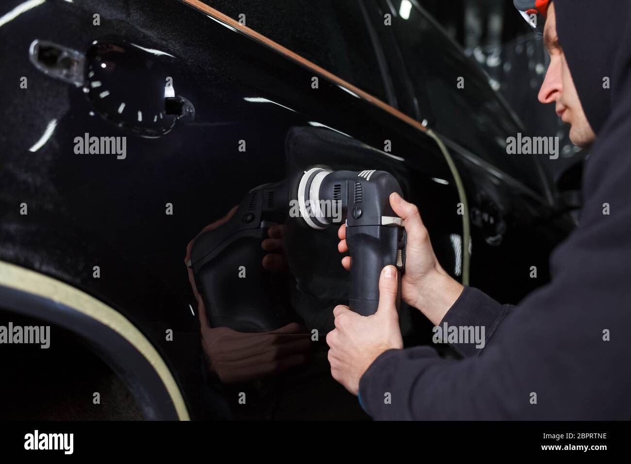 Auto polishing process. Detailing worker polishes car body Stock Photo Alamy