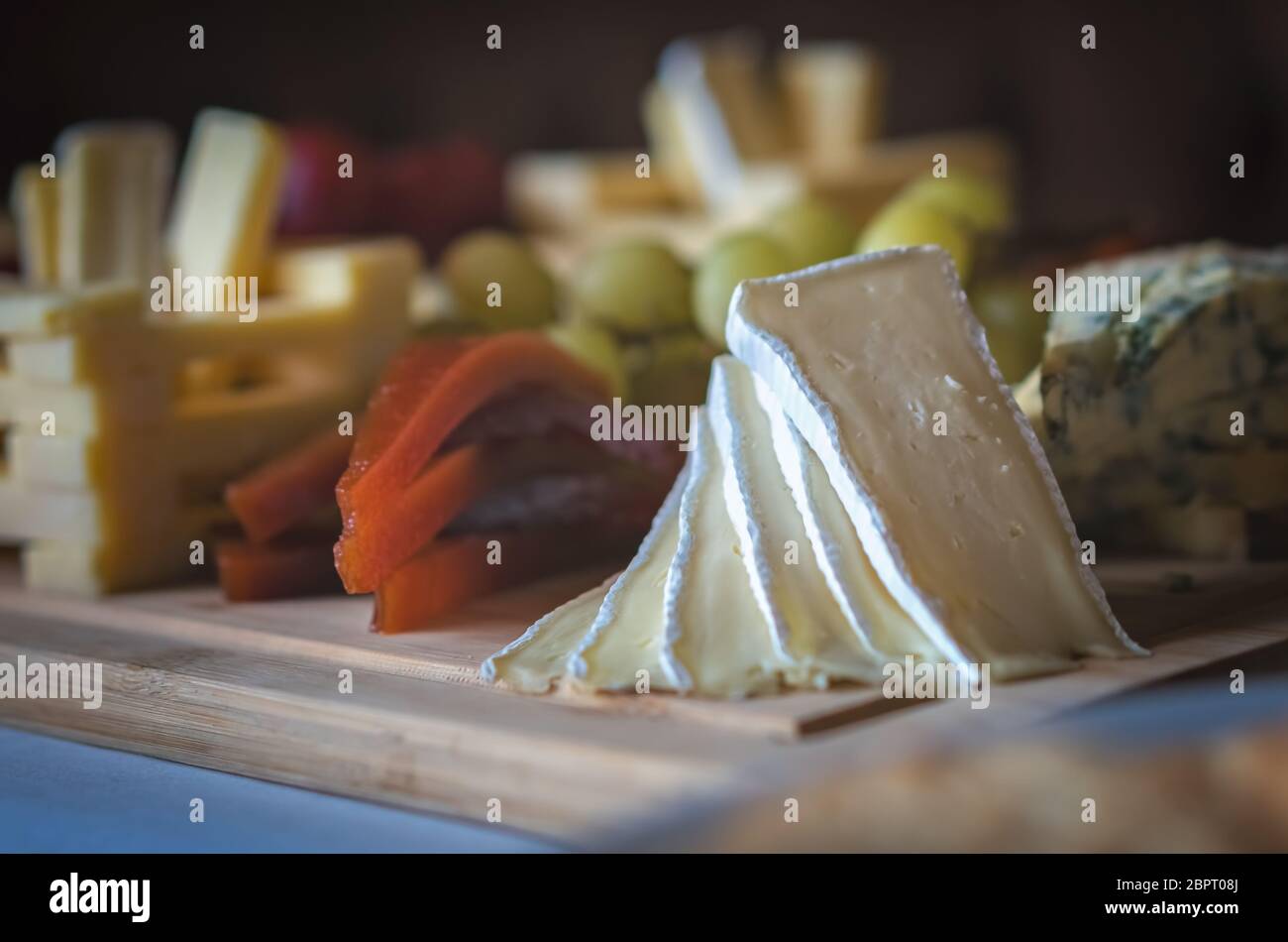 Cheese platter with different cheeses including brie, cheddar and blue