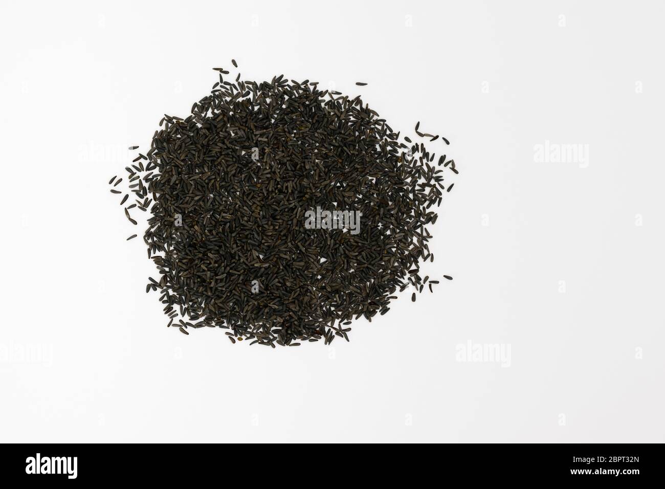 Blackseeds or Niger seeds (Guizotia abyssinica) on a white background Stock Photo