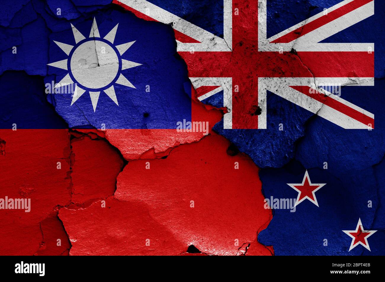 flags of Taiwan and New Zealand painted on cracked wall Stock Photo