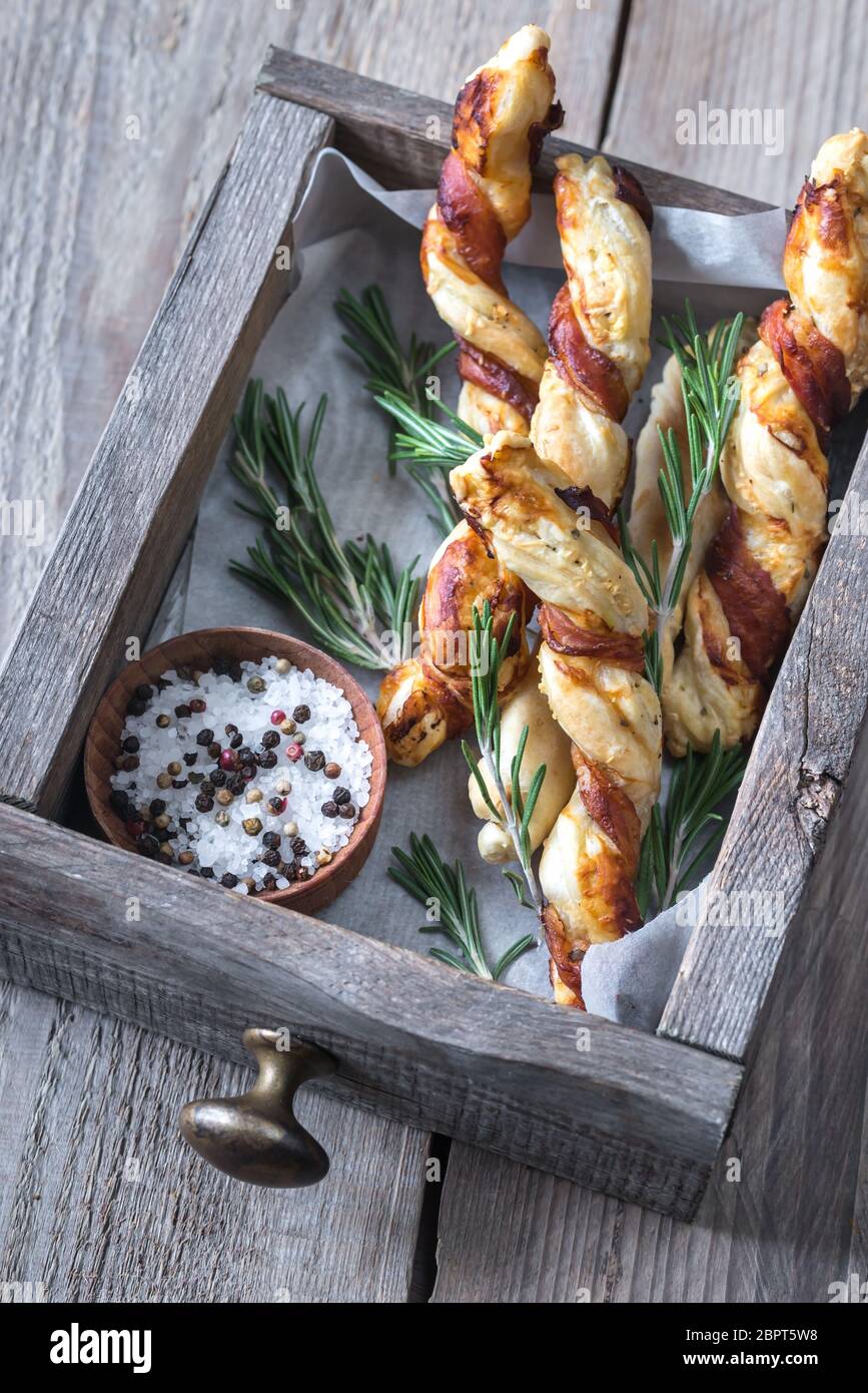 Baconwrapped breadsticks on the wooden tray Stock Photo Alamy
