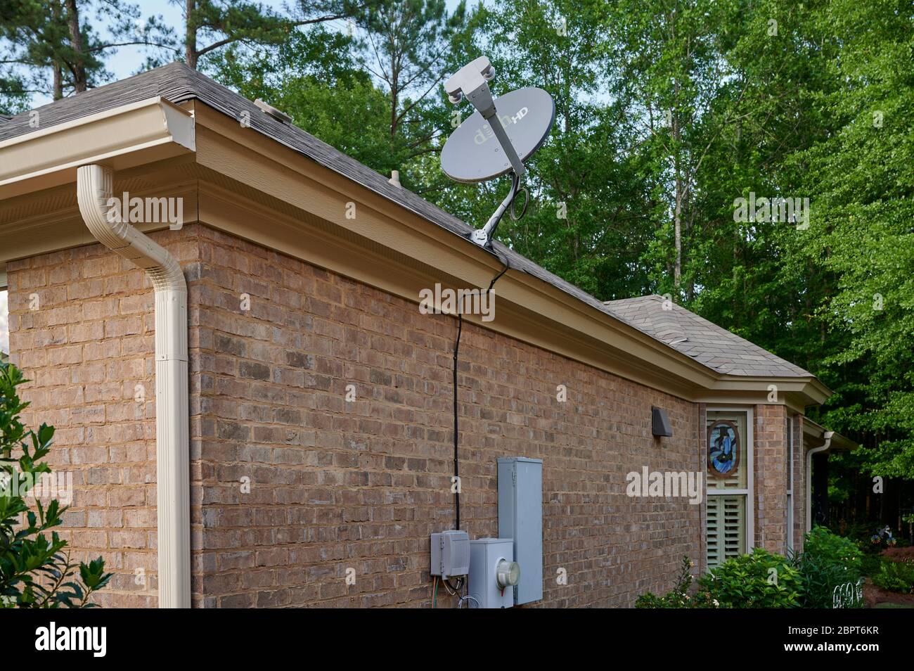 Dish TV, television, home satellite antenna  on roof of house in USA. Stock Photo