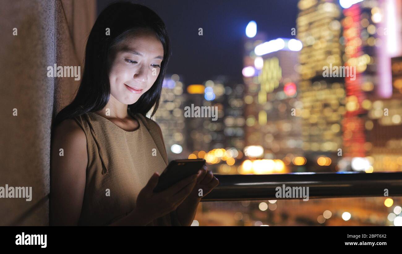 Woman working on cellphone in Hong Kong Stock Photo - Alamy