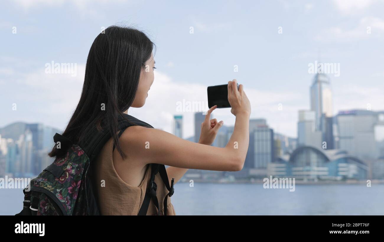 Woman taking photo in Hong Kong city Stock Photo - Alamy