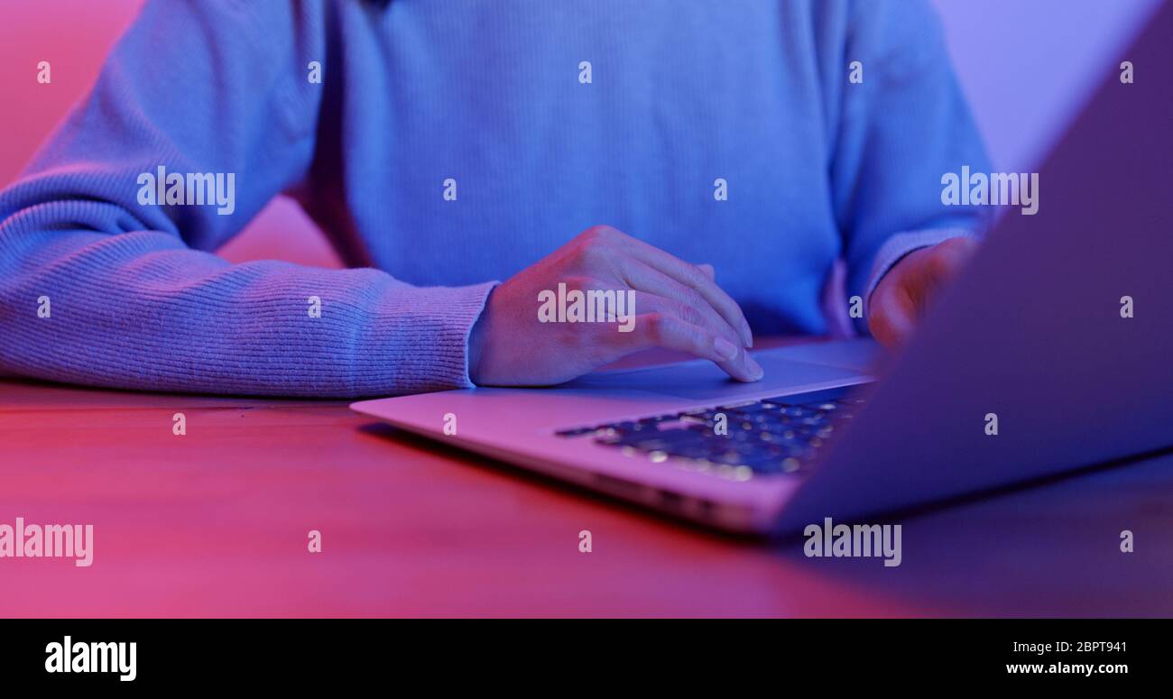 Work on laptop computer with purple light Stock Photo - Alamy