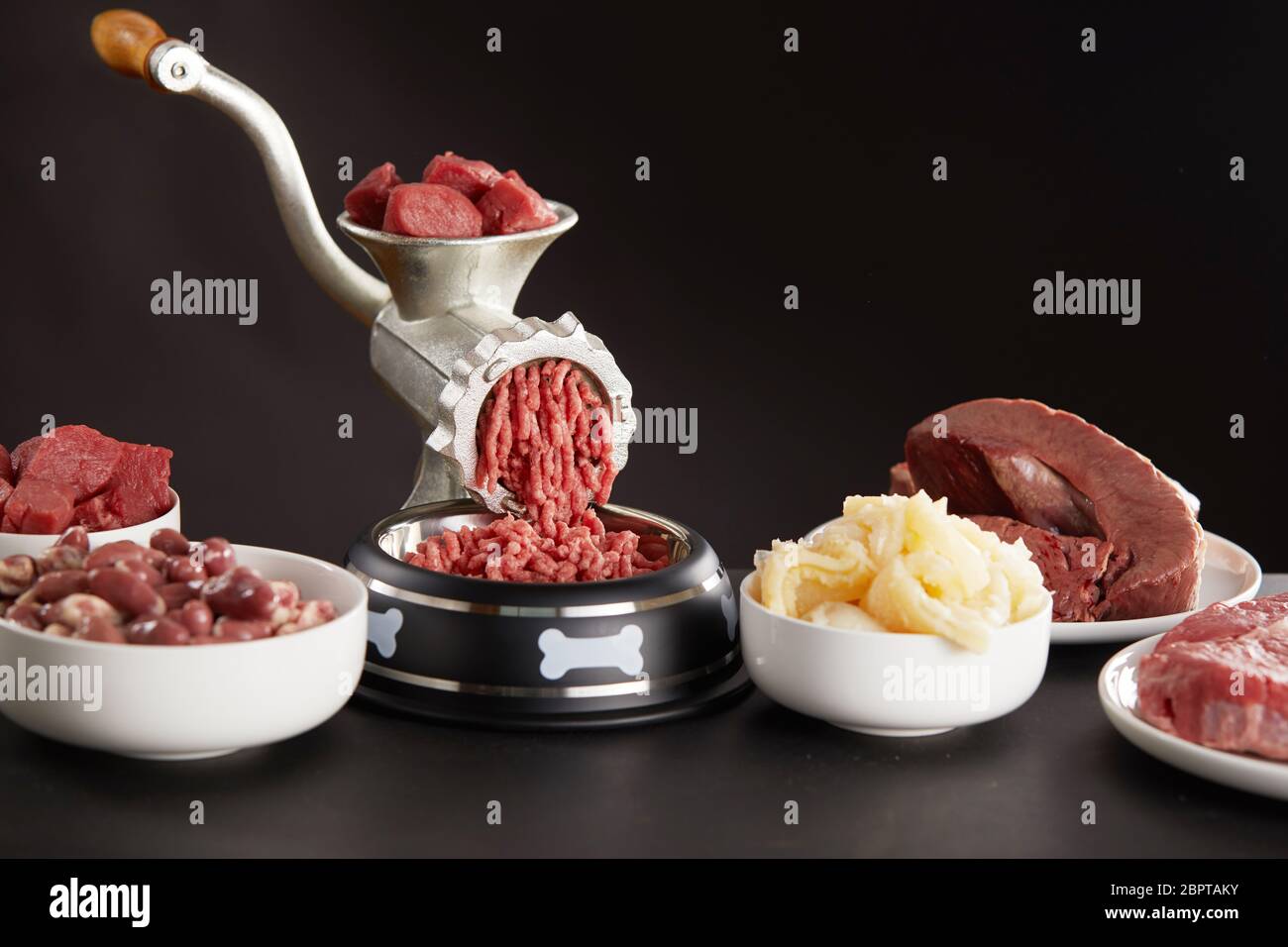Preparing fresh raw meat for barf dog food with a mix of poultry