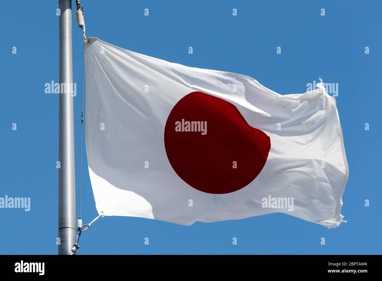 Japan Flag Waving with blue sky background Stock Photo - Alamy