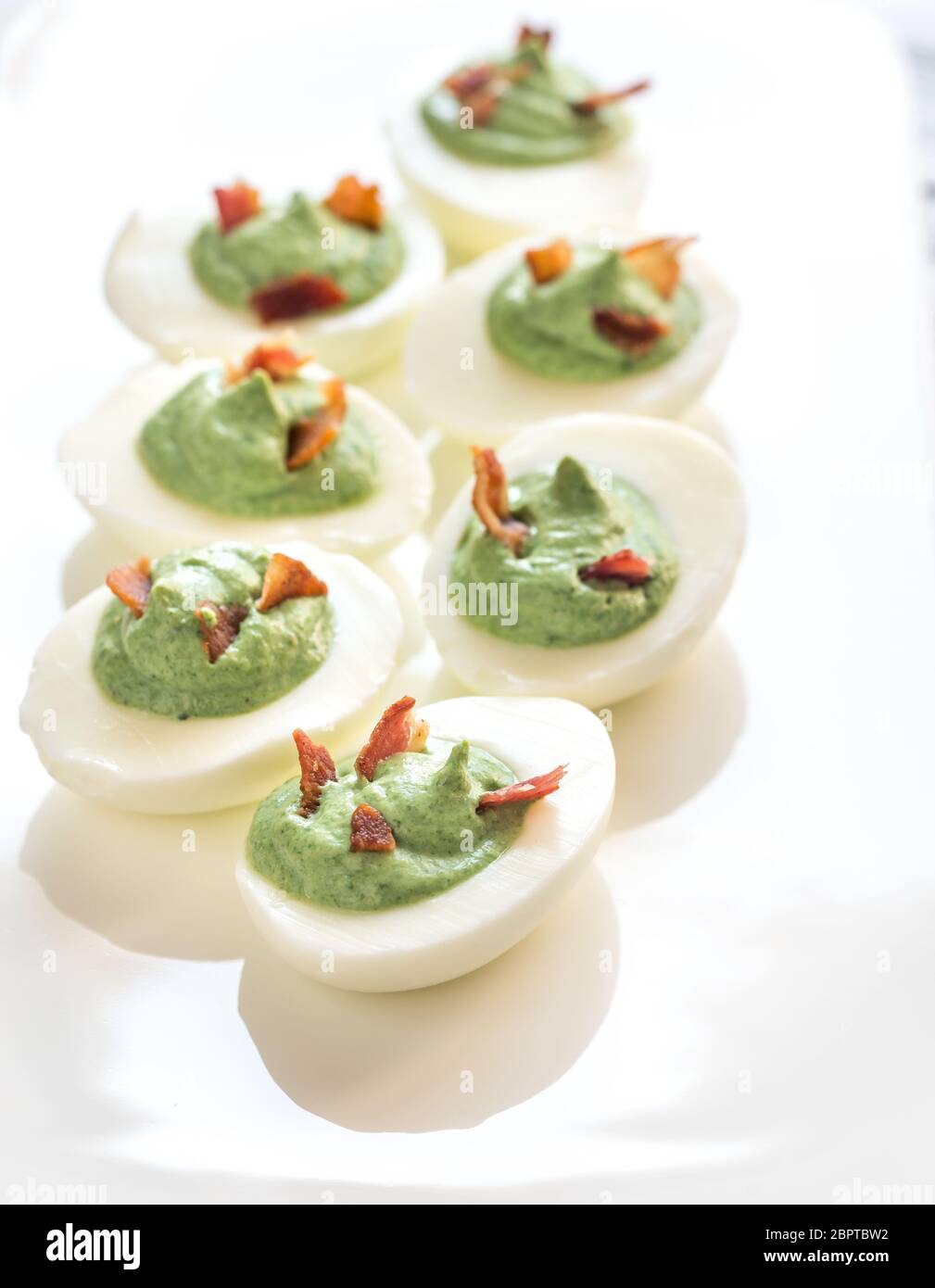 Spinach and bacon deviled eggs Stock Photo