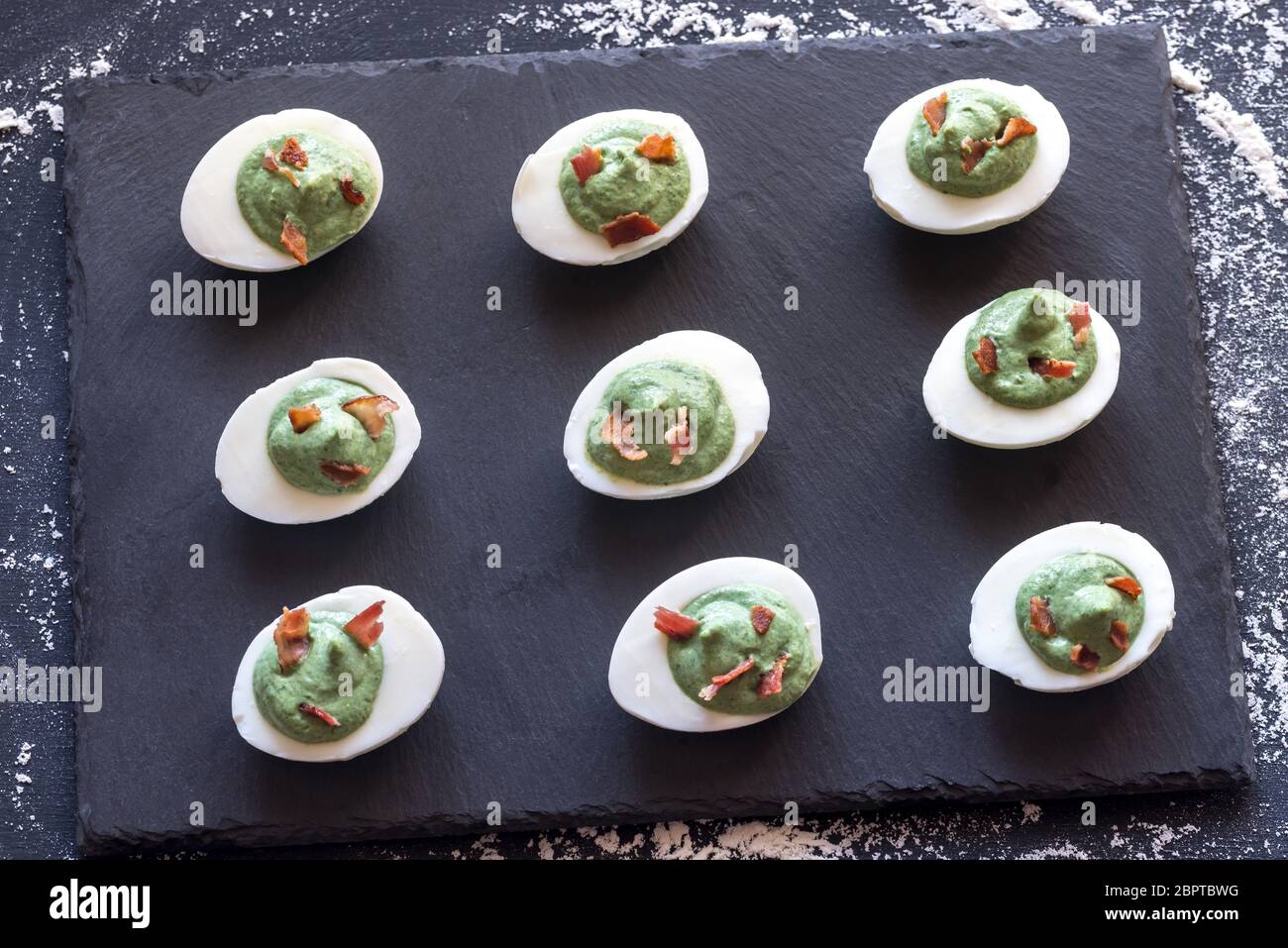 Spinach and bacon deviled eggs Stock Photo