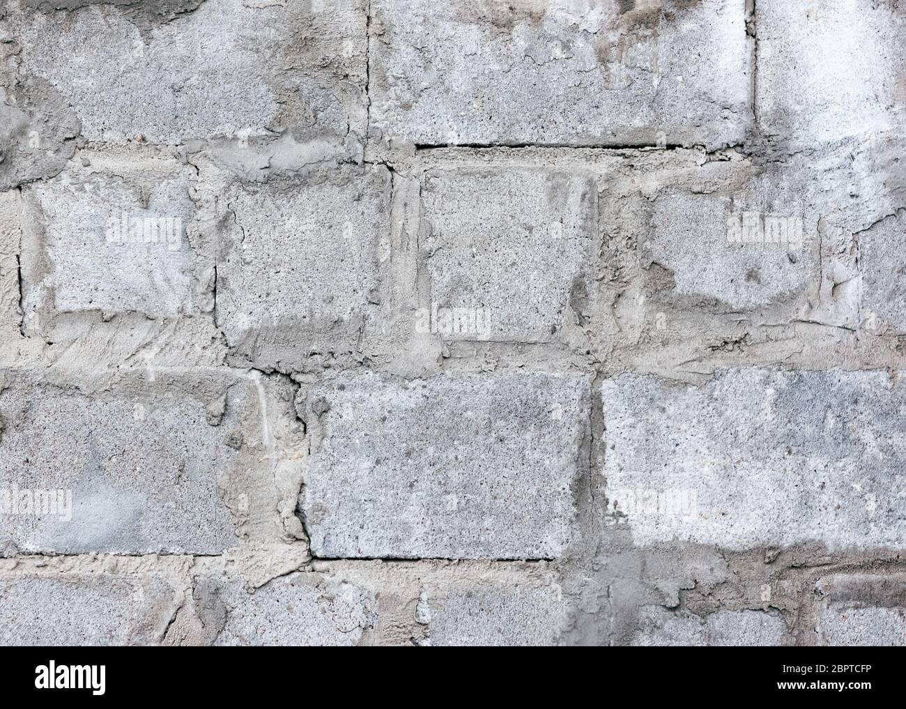 Old wall of concrete block masonry closeup. Grunge rough cement texture