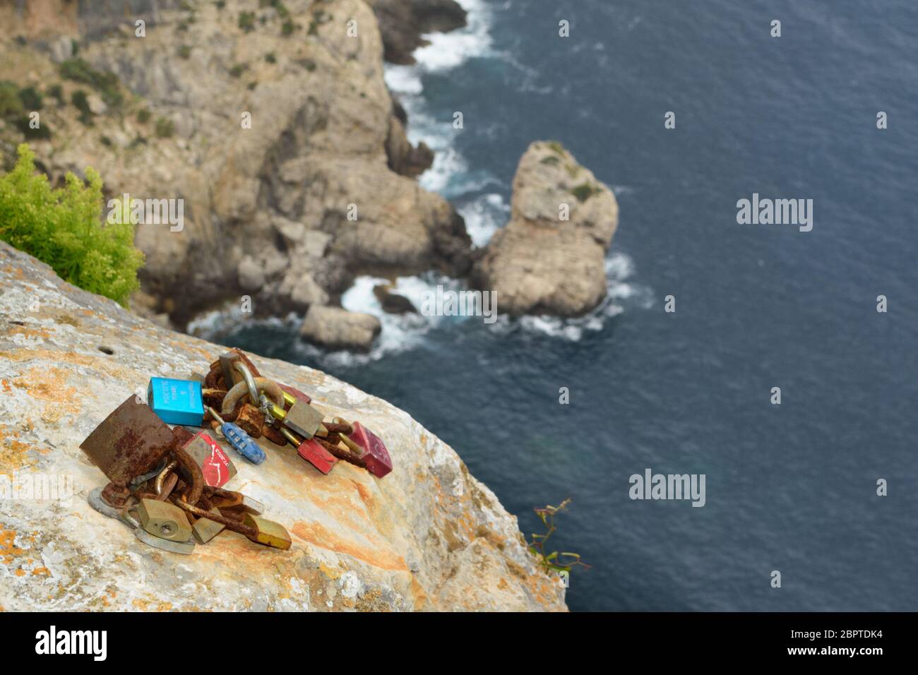 Love locks on the cliffs at Cap Formentor: lovelocks are considered a symbol of undying devotion for some people but an act of vandalism for others Stock Photo