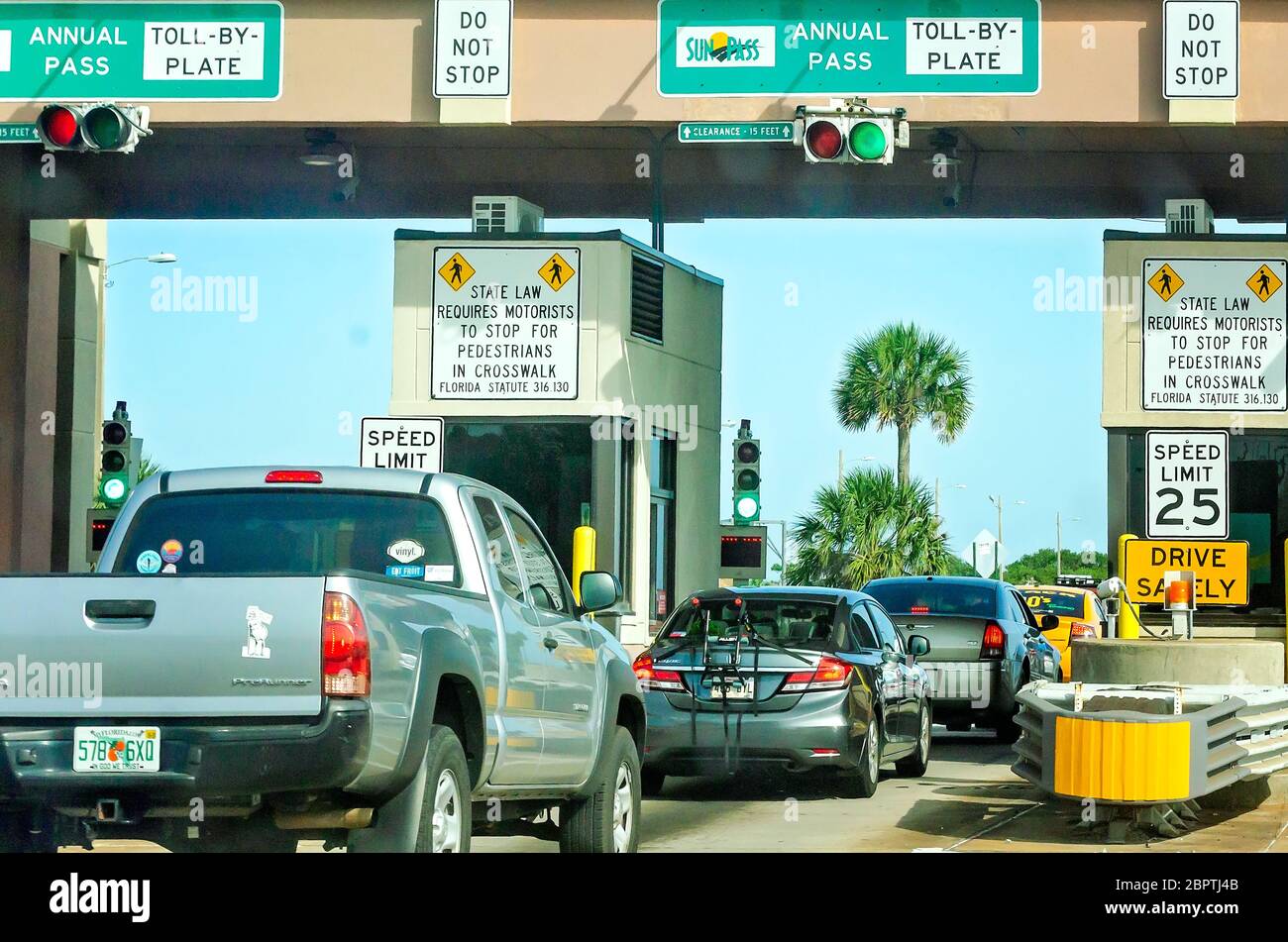 Traffic enters the Pensacola Beach Bridge toll booth, May 16, 2020, in Gulf Breeze, Florida. The beach recently reopened after closing for COVID-19. Stock Photo