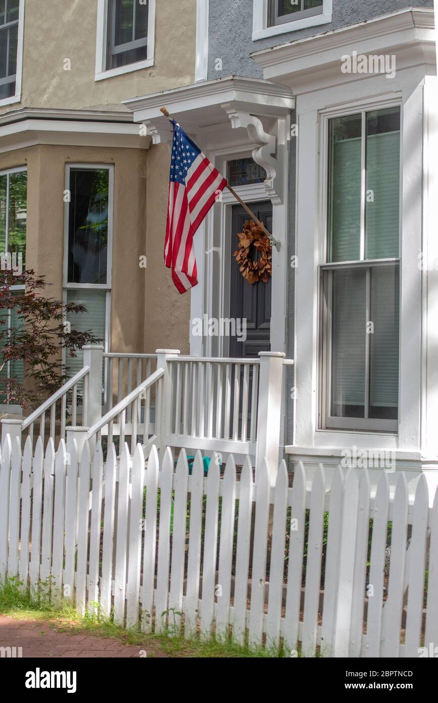 White picket fence adds to the Americana charm of this row house in the Logan neighborhood of Washington, DC. Stock Photo