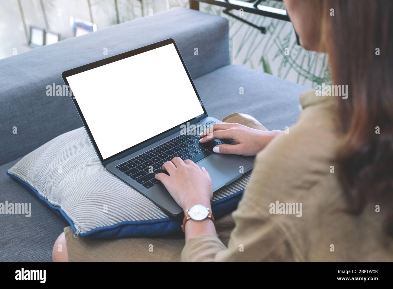 Mockup image of a woman using and typing on laptop keyboard with blank ...