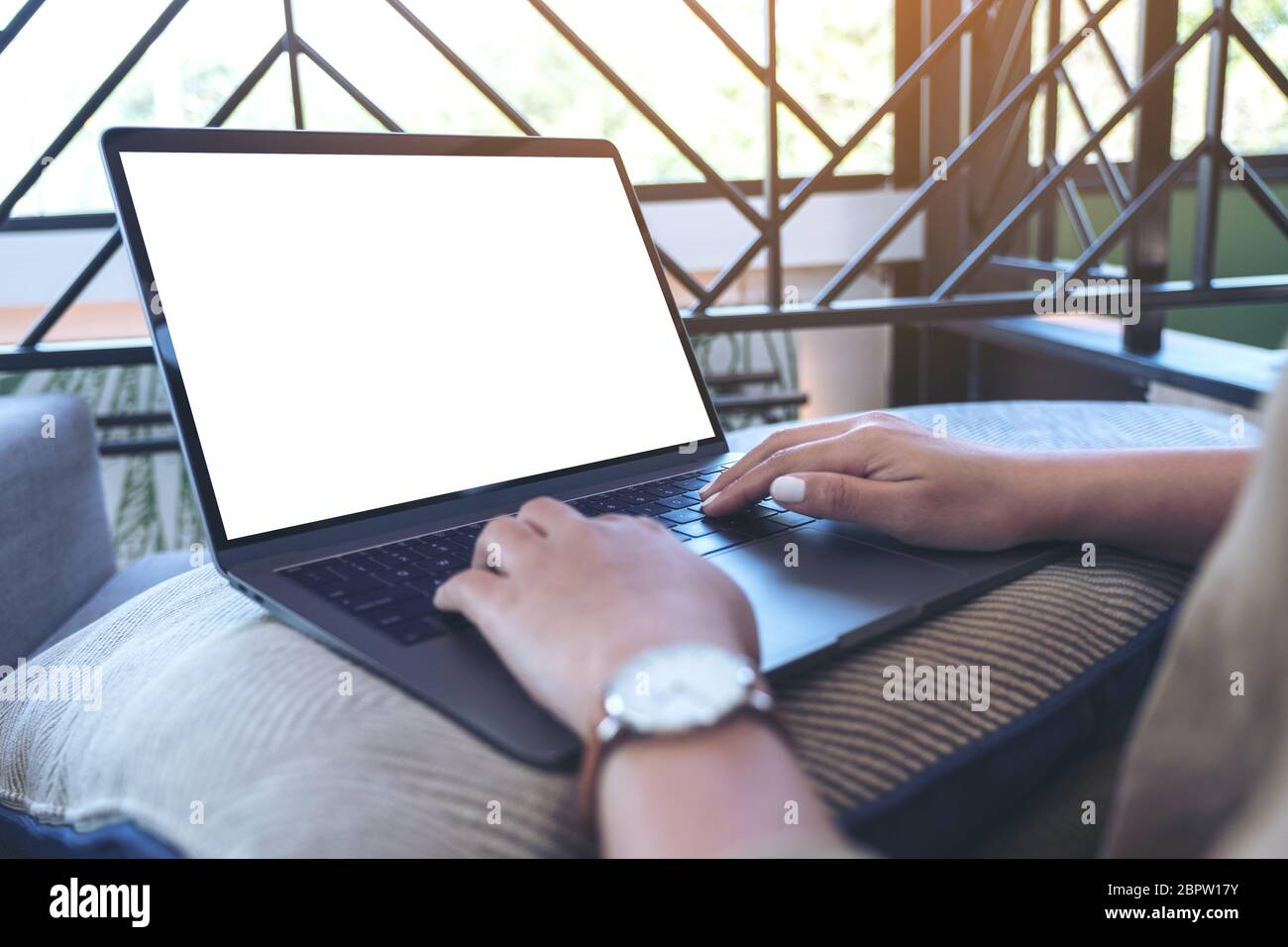 Mockup image of a woman using and typing on laptop keyboard with blank ...