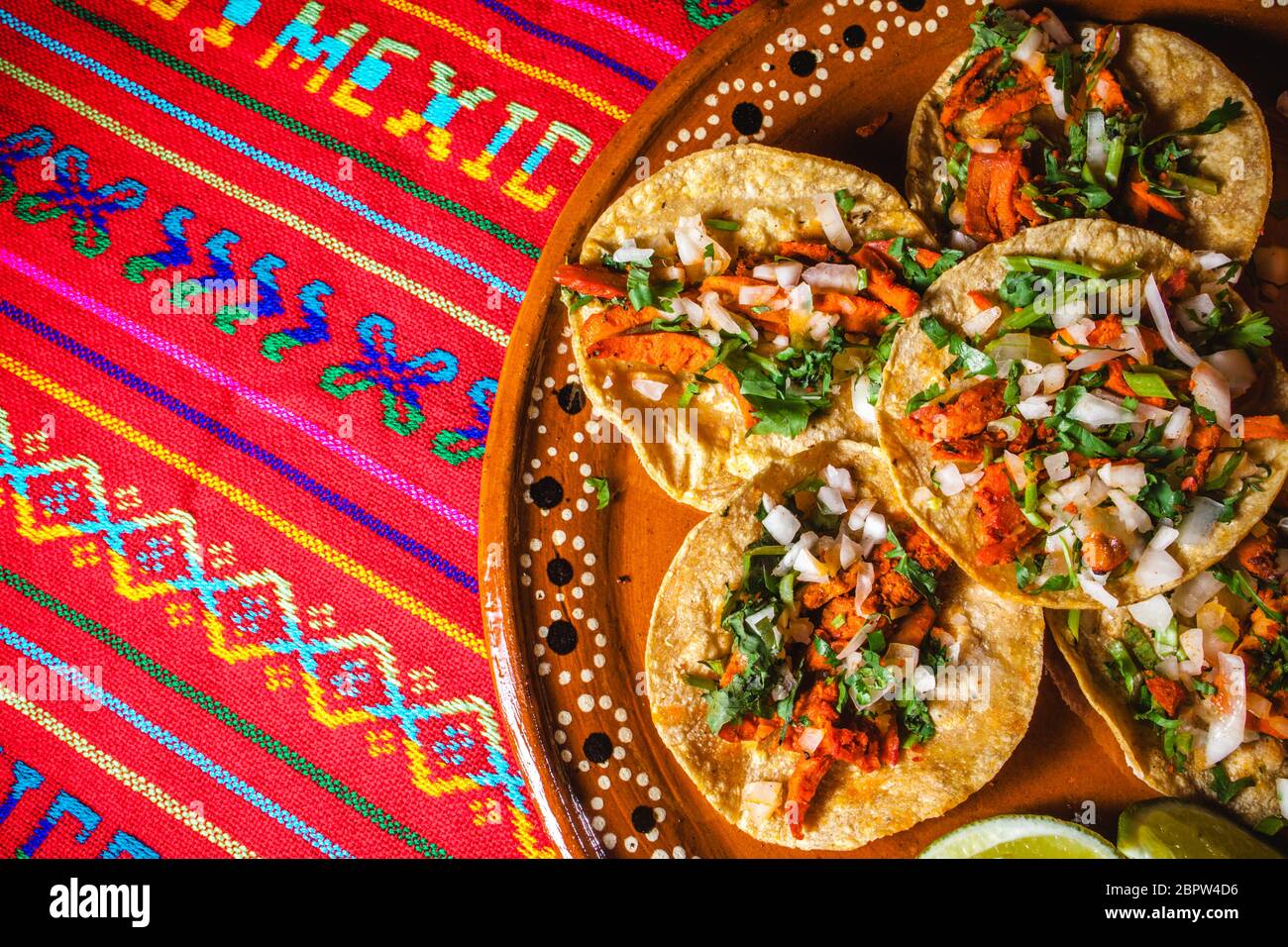 Mexican tacos al pastor, tortillas with pork and vegetables in Mexico