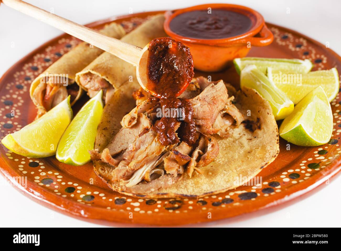 Mexican Carnitas tacos is traditional pork taco with corn tortilla and