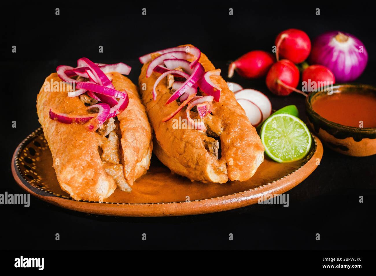 tortas ahogadas, traditional Mexican Food from Jalisco Guadalajara Mexico, spicy sandwich in a red sauce Stock Photo