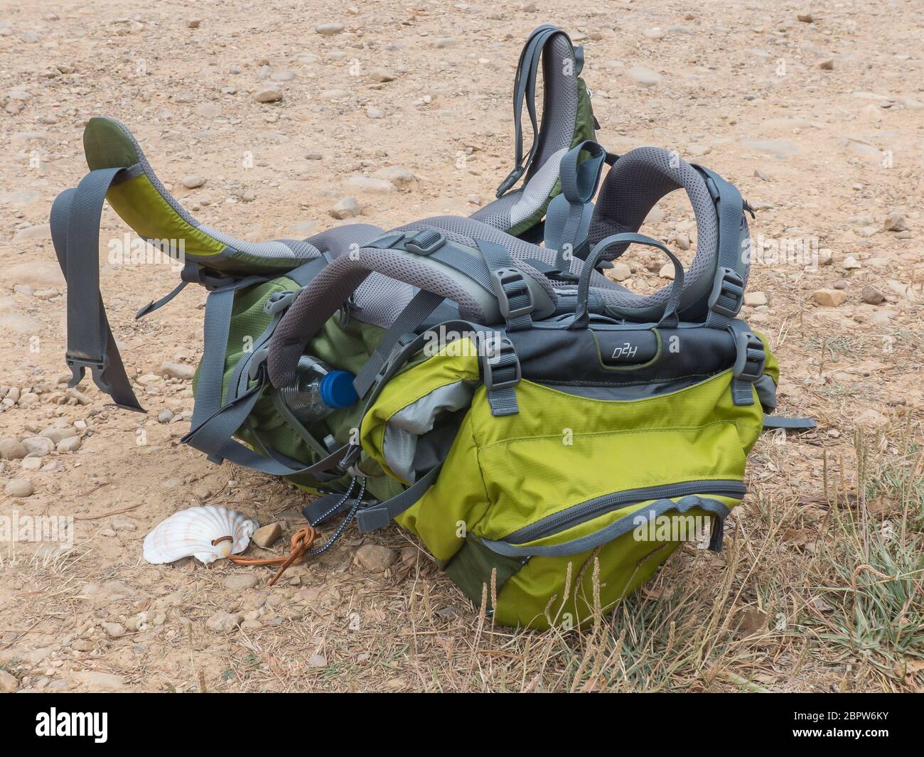 Back Pack with a St James scallop lying on the ground Stock Photo