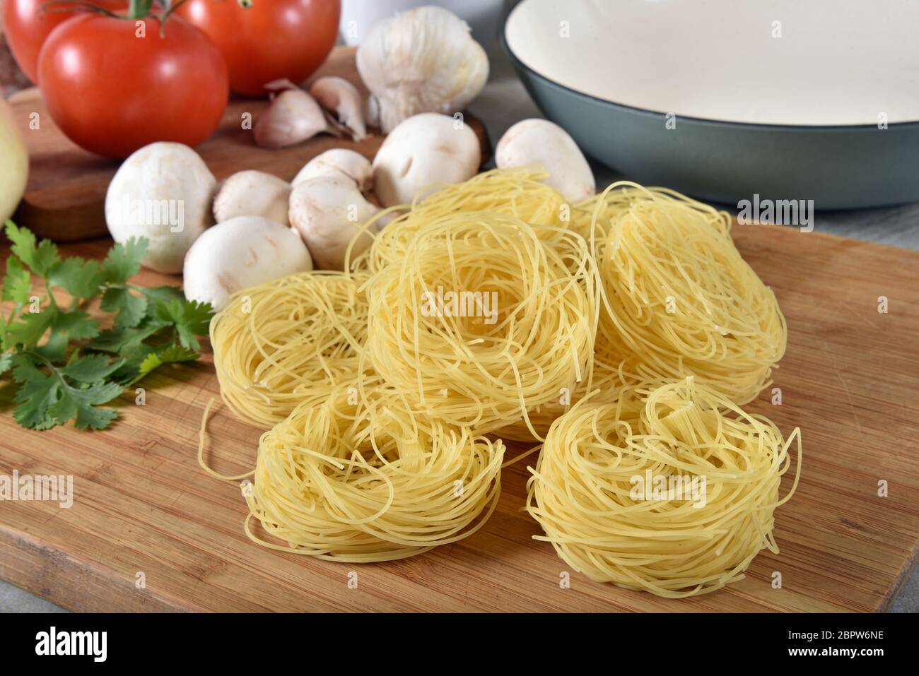 Ingredients to make spaghetti with angel hair pasta nests Stock Photo