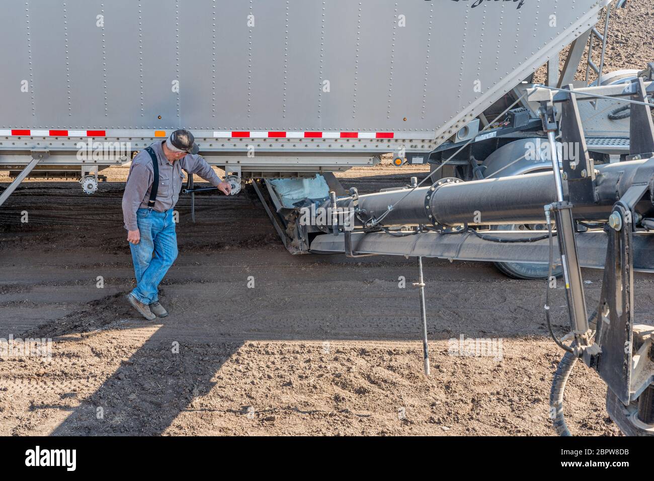 Swift Current, SK/Canada- May 15, 2020:  Farmer loading fertilizer from the Super-B into the Bourgault auger for seeding in Saskatchewan, Canada Stock Photo