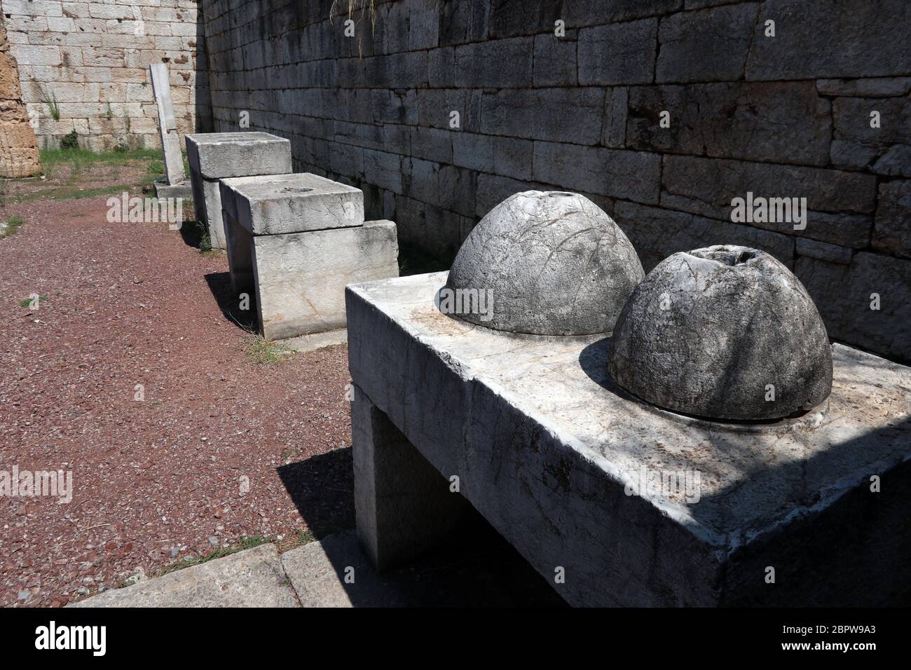 Stone measuring tables for testing capacity of containers used by grain and dried fruit merchants, Ancient Messini, Greece Stock Photo