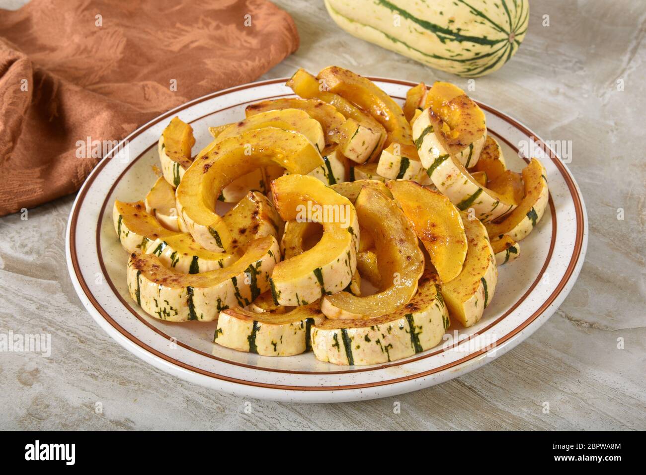 Roasted delicata squash slices in a brown sugar cinnamon glaze Stock Photo