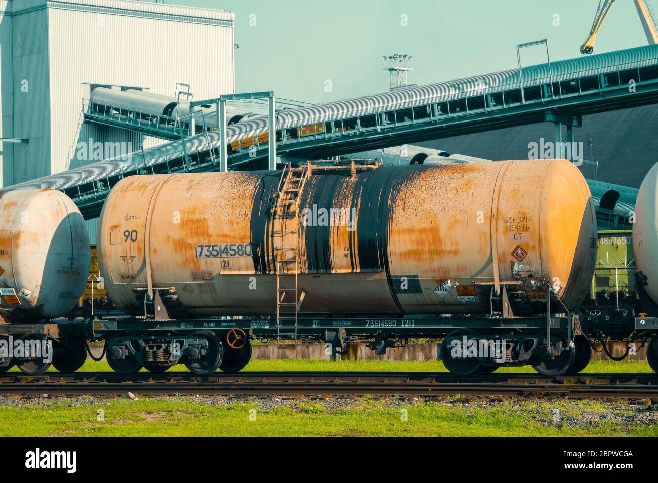 Oil train wagons on oil refinery Stock Photo - Alamy