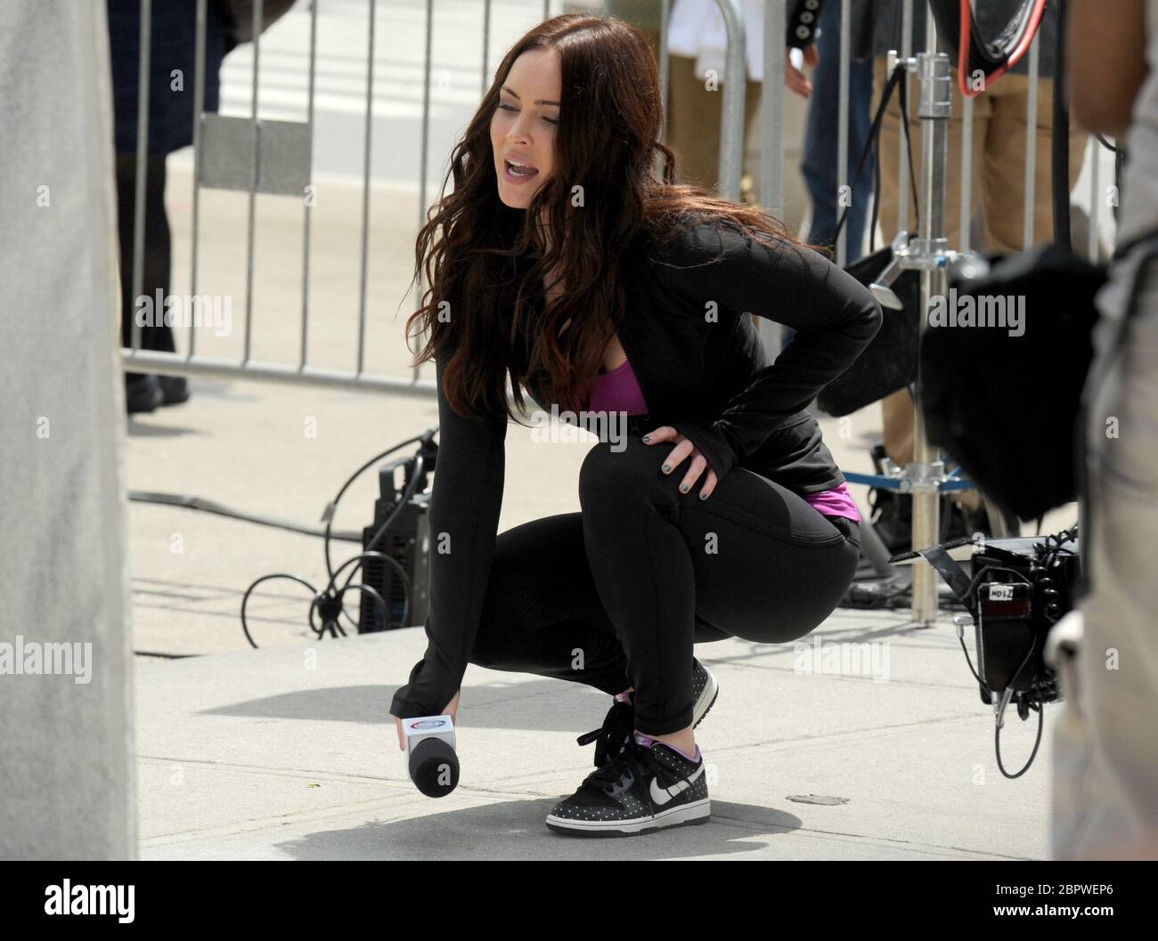 NEW YORK, NY - MAY 07: Megan Fox on the set of Teenage Mutant Ninja Turtles  in New York City May 7. Wearing black yoga pants and a tight purple tank  top,