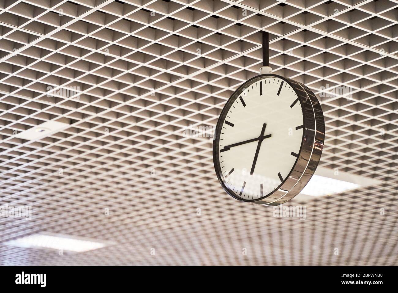 Modern clock with dial on structured wall background in black and white with chrome Stock Photo
