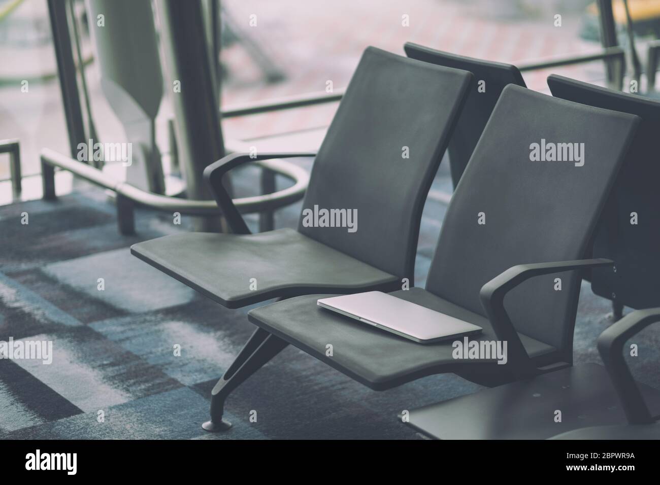 Passenger lost laptop computer on the airport chair Stock Photo Alamy