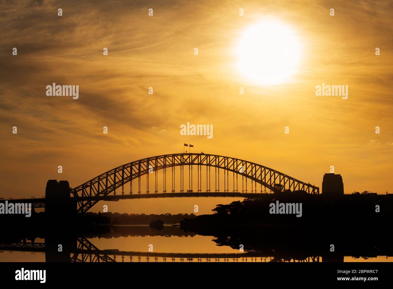 Sun setting over the famous Harbour Bridge. Stock Photo