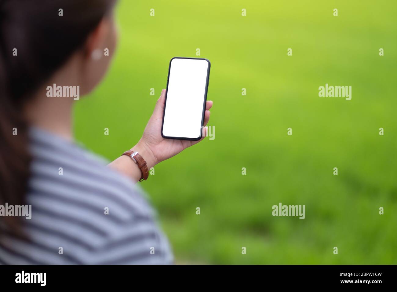 Mockup image of a woman holding black mobile phone with blank desktop ...