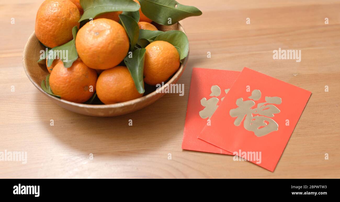 Mandarin orange for lunar new year with red packet chinese word means
