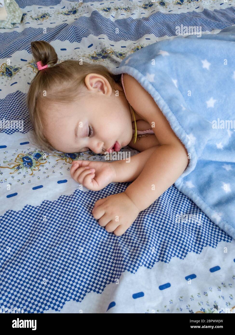 Above view of little girl in bed. Stock Photo