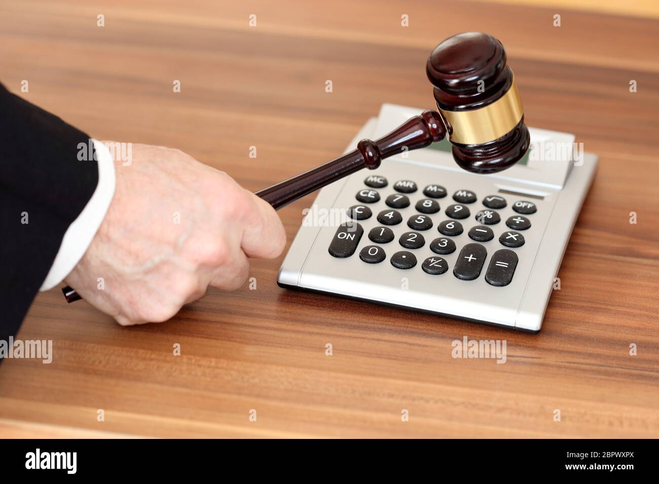 auction symbol with calculator and gavel on a wooden background Stock
