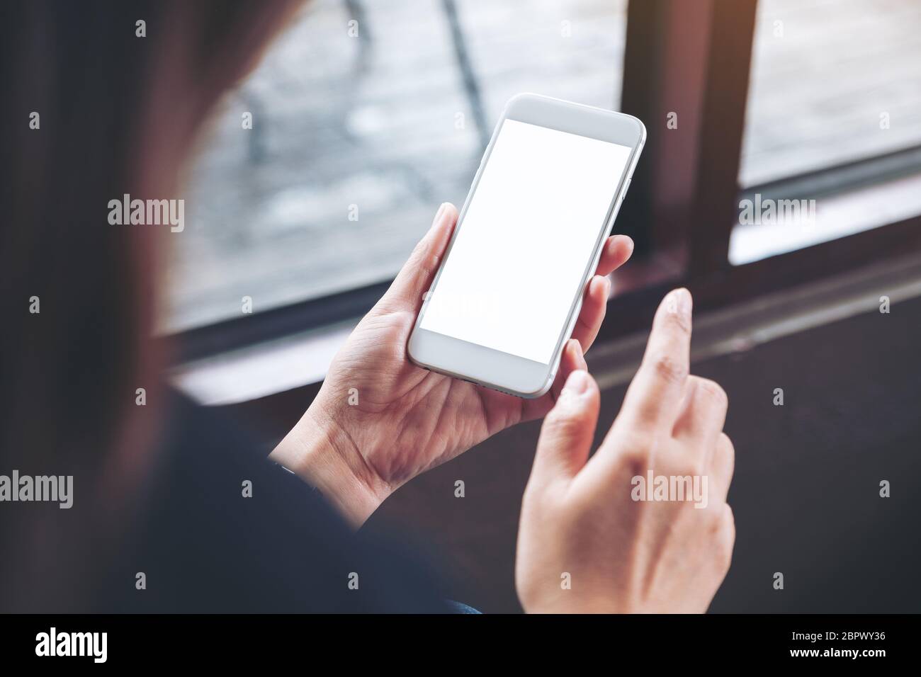 Mockup image of a woman holding white mobile phone with blank desktop ...