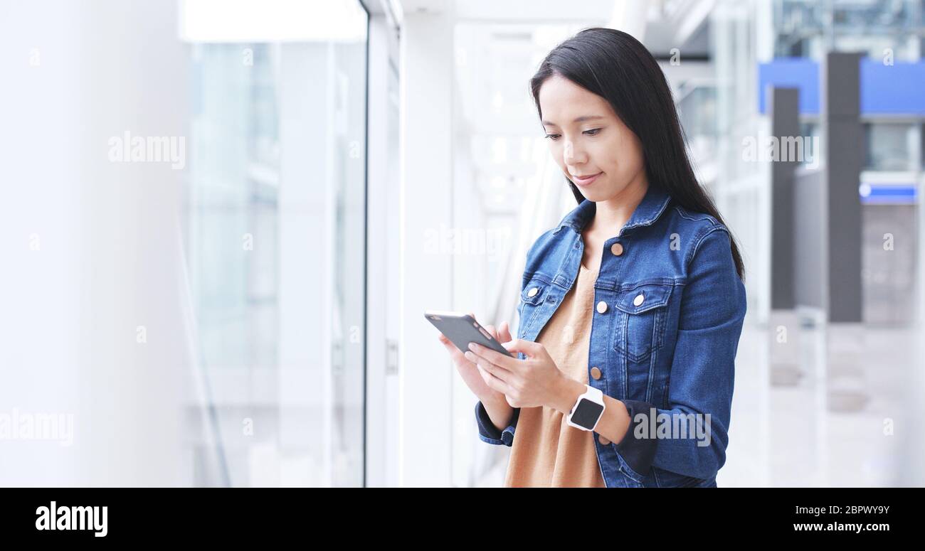 Woman use of smart phone in Hong Kong international airport Stock Photo ...