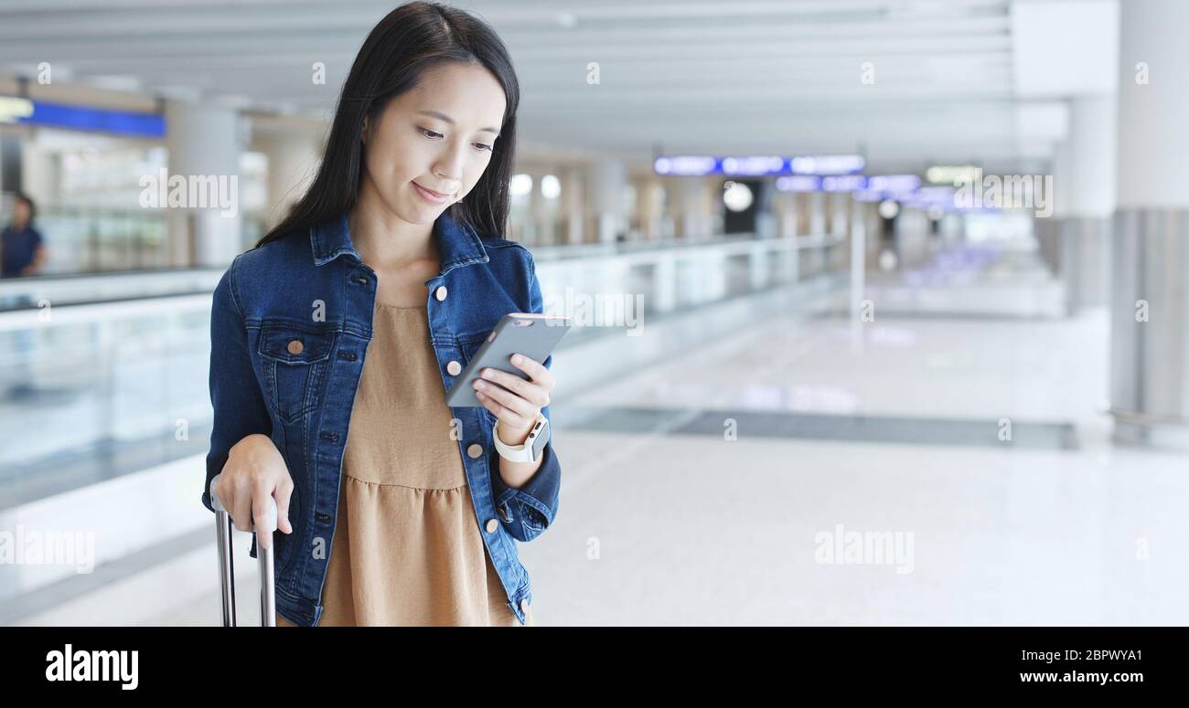 Woman using mobile phone at Hong Kong airport Stock Photo - Alamy