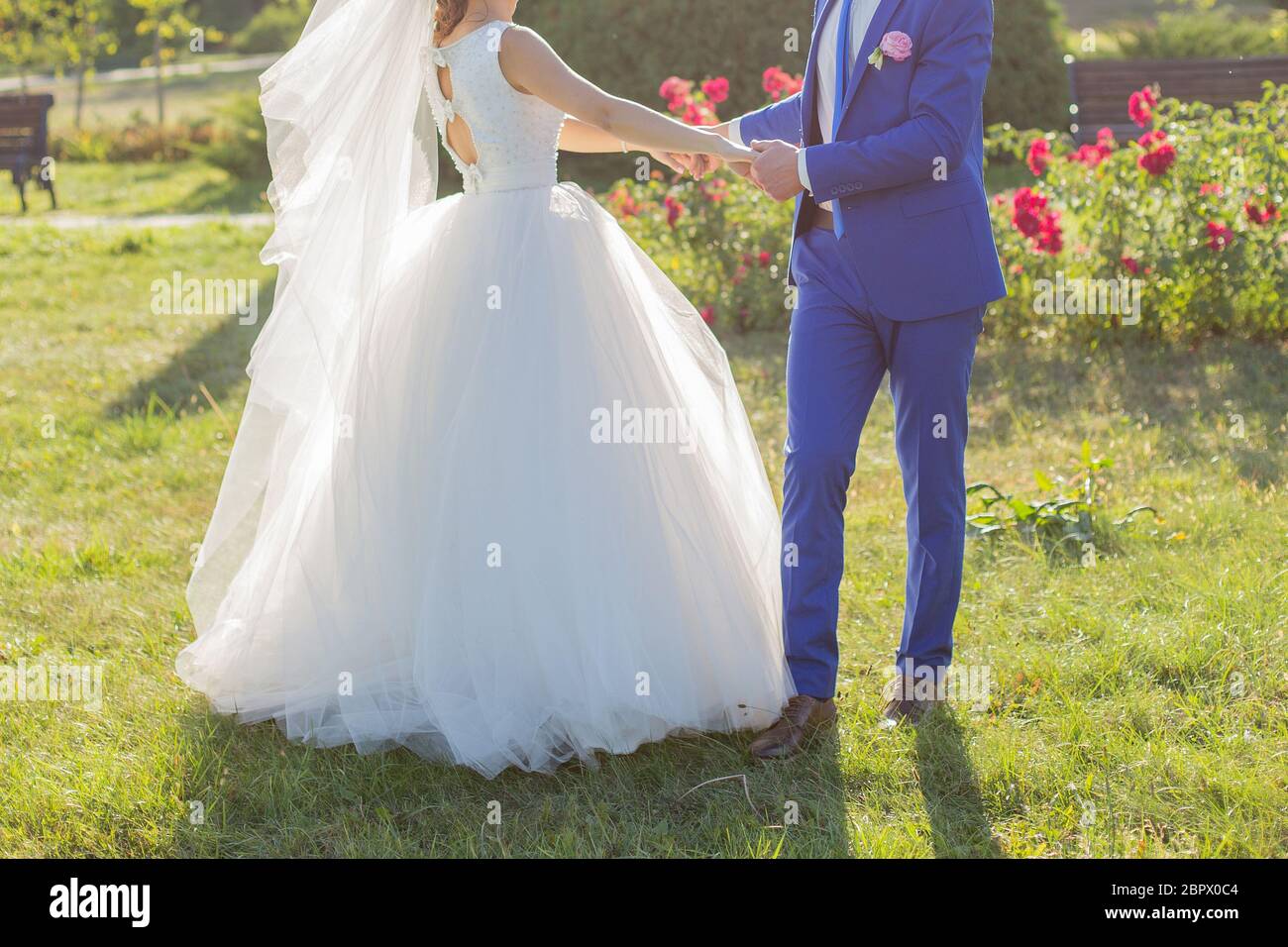 bride and groom in park among the trees Stock Photo - Alamy
