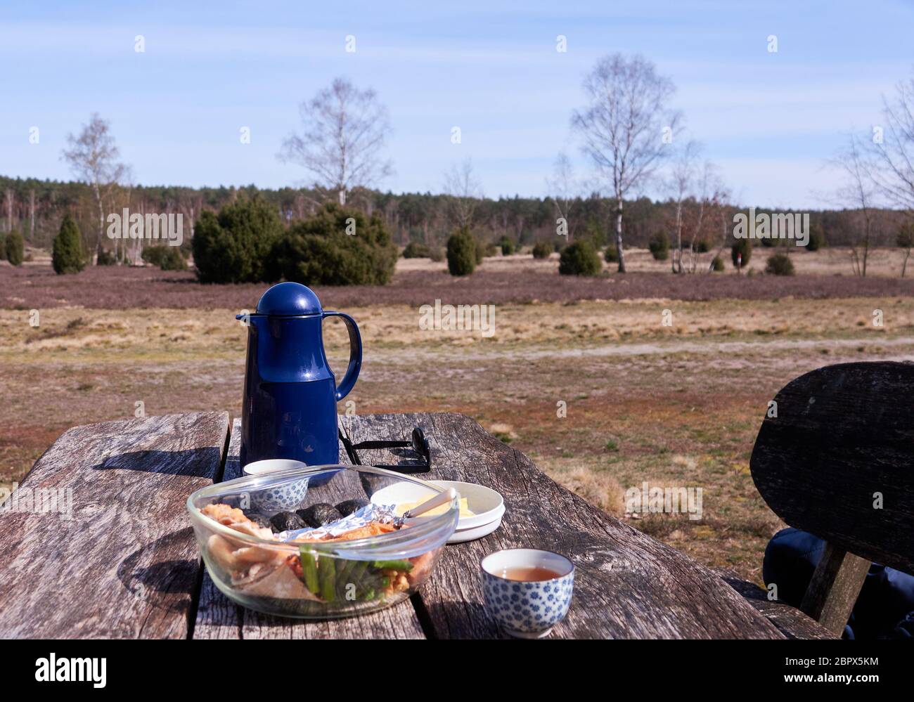 Picnic in the heath on a rustic wooden table Stock Photo