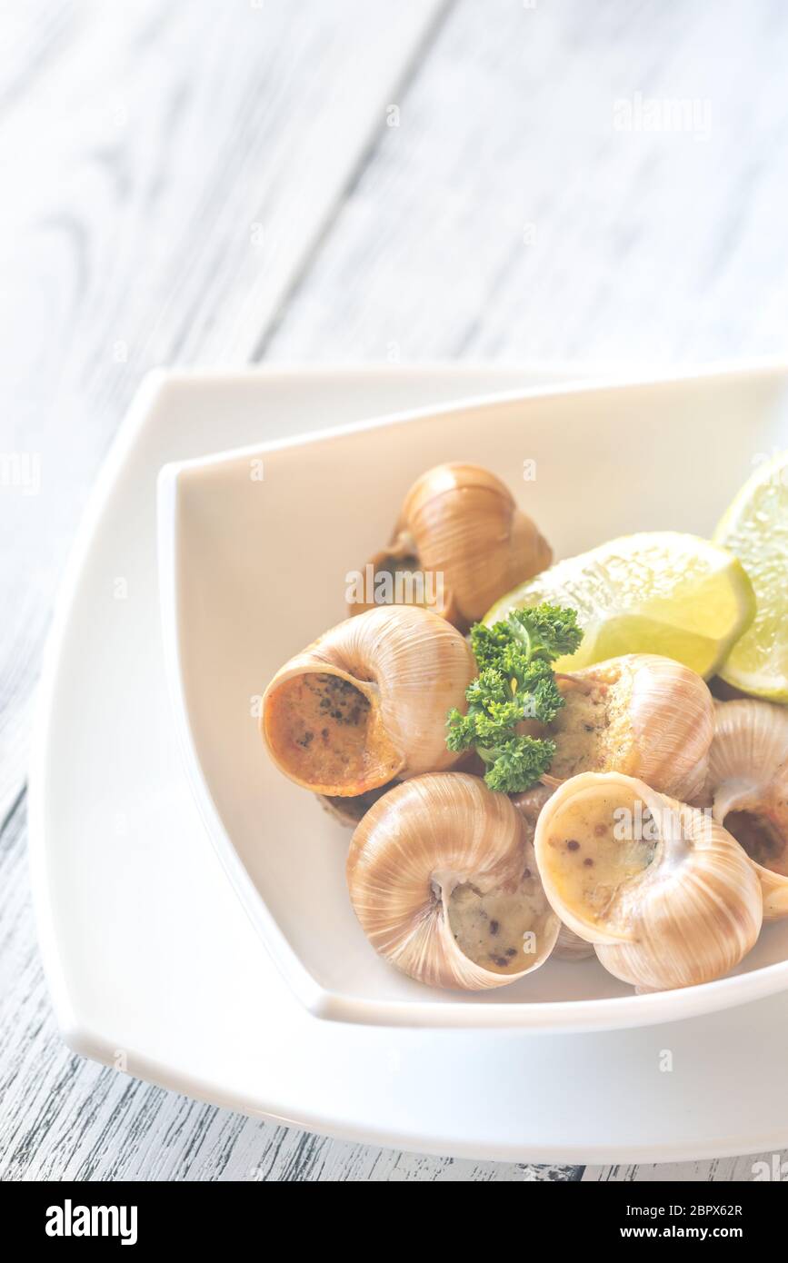 Portion of cooked snails Stock Photo Alamy